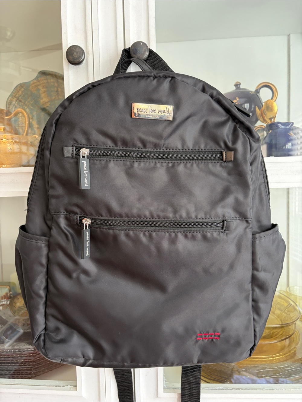 Peace Love World Black Nylon Backpack with Red Accent